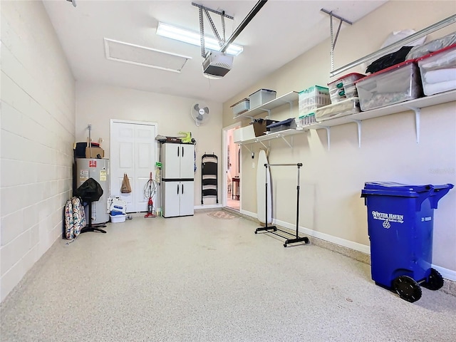 garage with water heater, concrete block wall, and a garage door opener