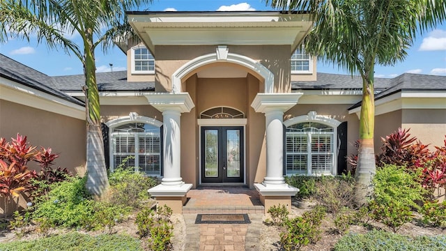 property entrance featuring french doors and stucco siding