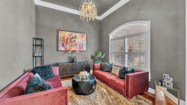 living area featuring baseboards, ornamental molding, wood finished floors, and a notable chandelier