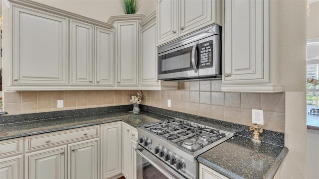 kitchen with tasteful backsplash and appliances with stainless steel finishes