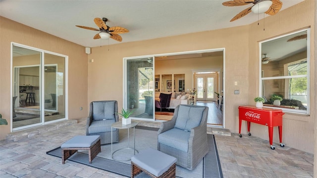 view of patio featuring a ceiling fan, french doors, and an outdoor living space