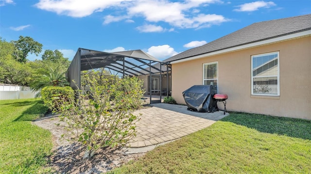 view of yard with a lanai, fence, and a patio