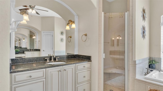 full bath featuring a garden tub, a shower stall, ceiling fan, and vanity