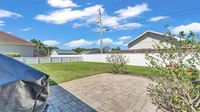 view of patio / terrace with grilling area and a fenced backyard