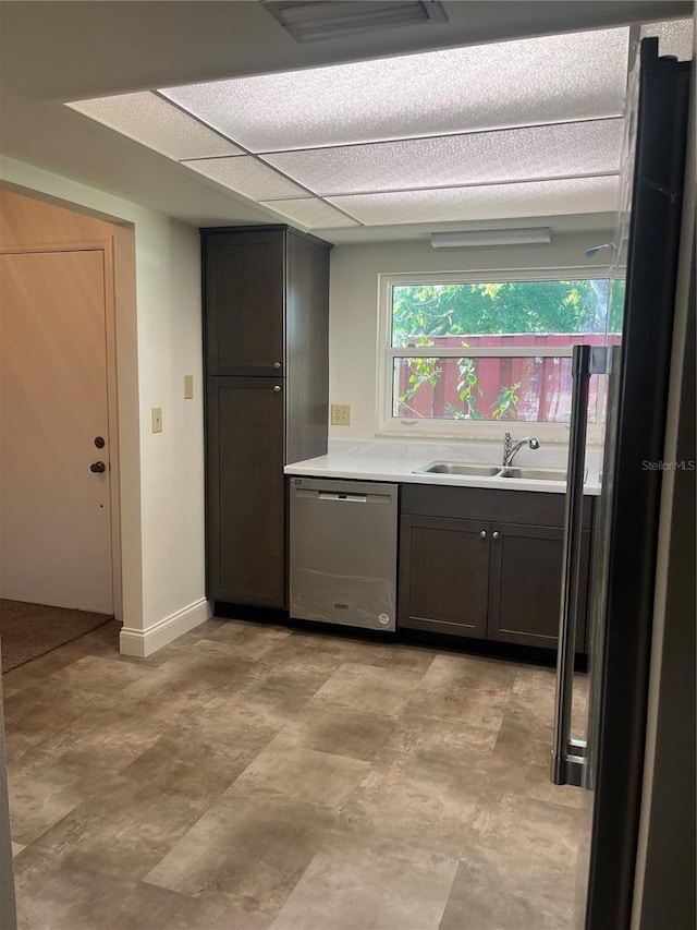 kitchen with a sink, dark brown cabinetry, light countertops, and stainless steel dishwasher