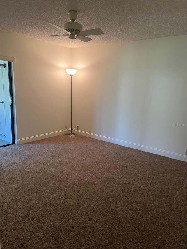 empty room featuring carpet flooring, ceiling fan, a textured ceiling, and baseboards