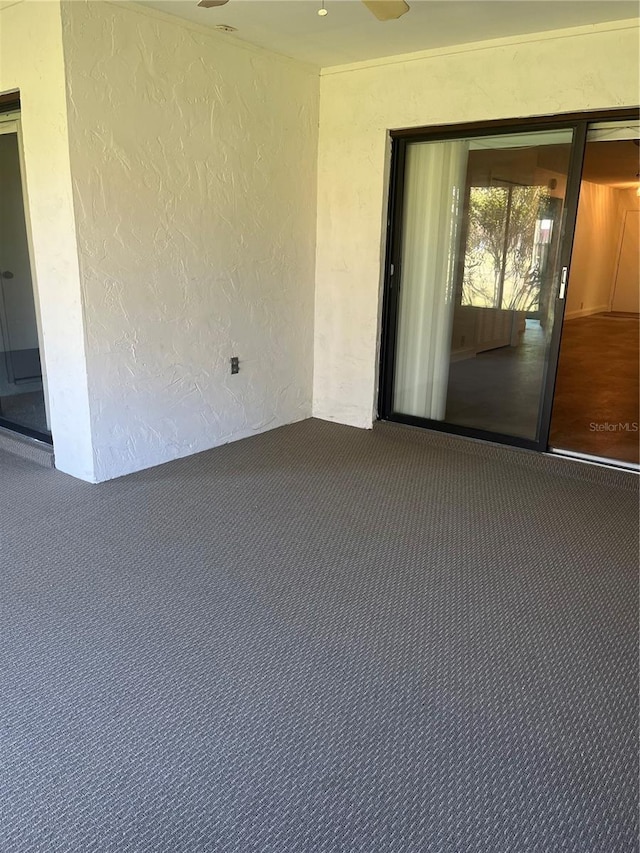 carpeted spare room with a textured wall