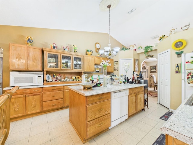 kitchen featuring a center island, arched walkways, lofted ceiling, light tile patterned flooring, and white appliances