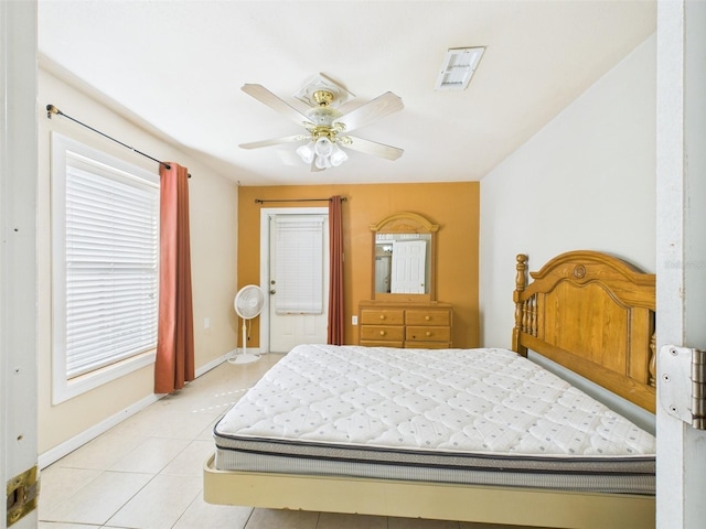 bedroom with light tile patterned floors, ceiling fan, and baseboards