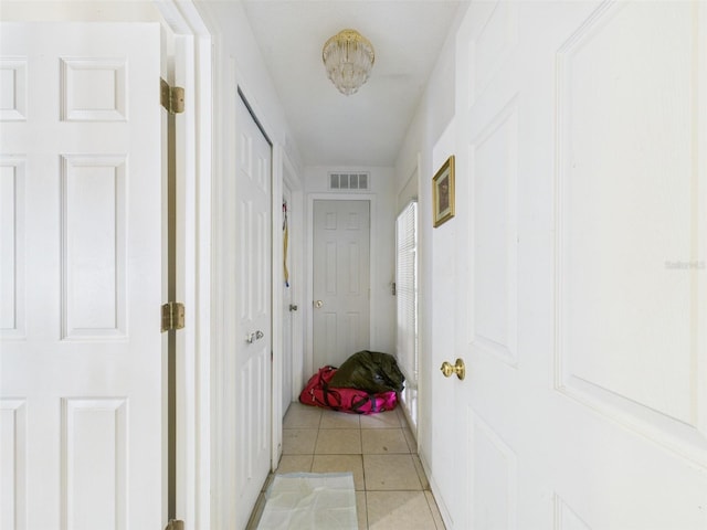 hallway with light tile patterned floors and visible vents