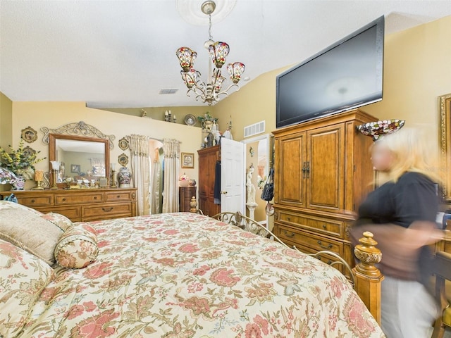 bedroom with an inviting chandelier, visible vents, and vaulted ceiling