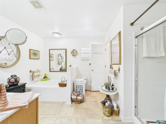 full bath featuring a garden tub, a shower stall, visible vents, and tile patterned flooring