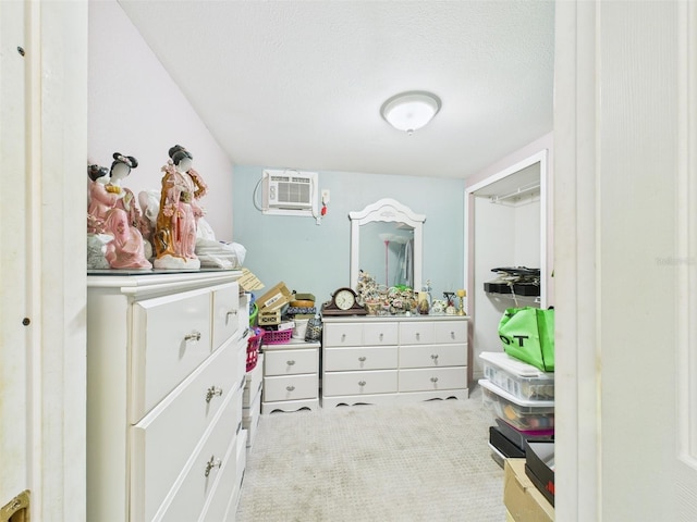 walk in closet featuring carpet floors and a wall mounted air conditioner