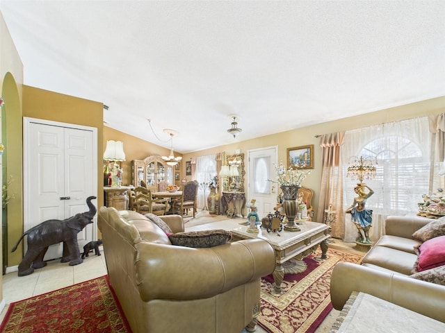 living room with lofted ceiling, arched walkways, and light tile patterned floors