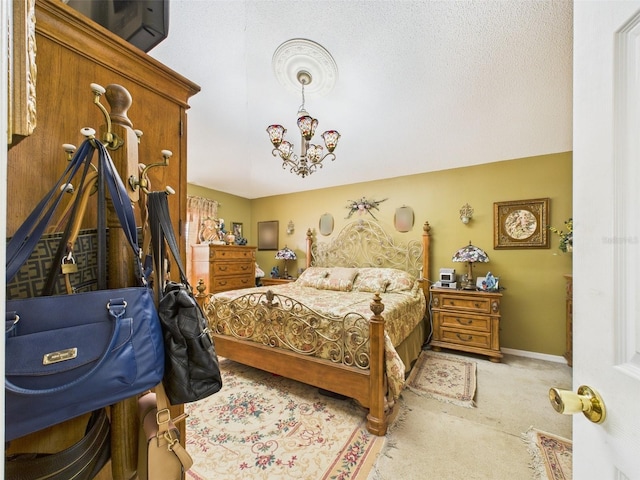 carpeted bedroom featuring baseboards and an inviting chandelier