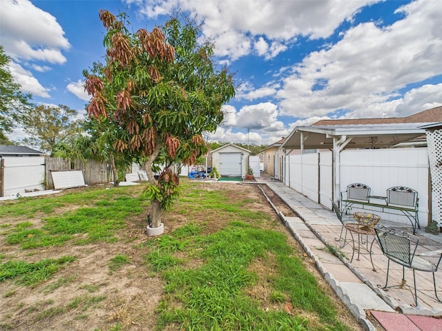 view of yard with fence and an outbuilding