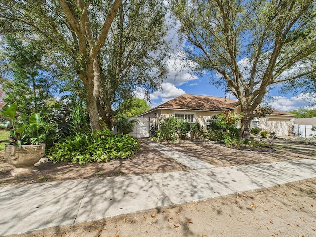 view of front of property with a garage and decorative driveway