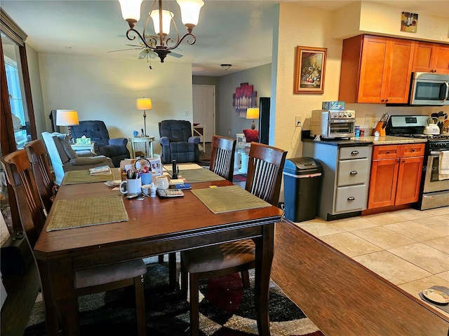 dining area featuring a chandelier and light tile patterned floors