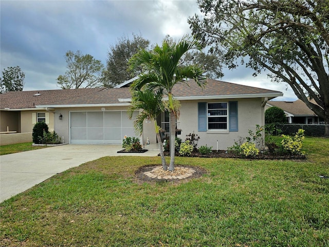 single story home featuring concrete driveway, stucco siding, an attached garage, fence, and a front yard