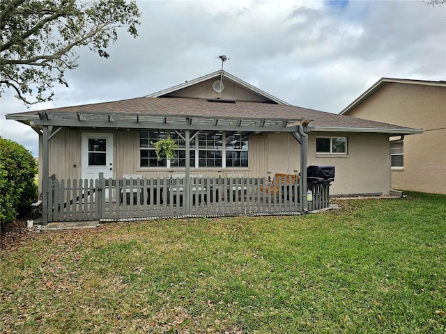 rear view of house featuring a pergola, a lawn, fence, and a patio