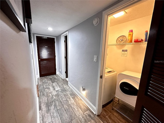 laundry room featuring washer / dryer, wood tiled floor, laundry area, and baseboards