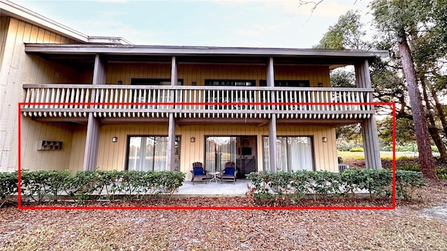 rear view of house with a patio area and a balcony