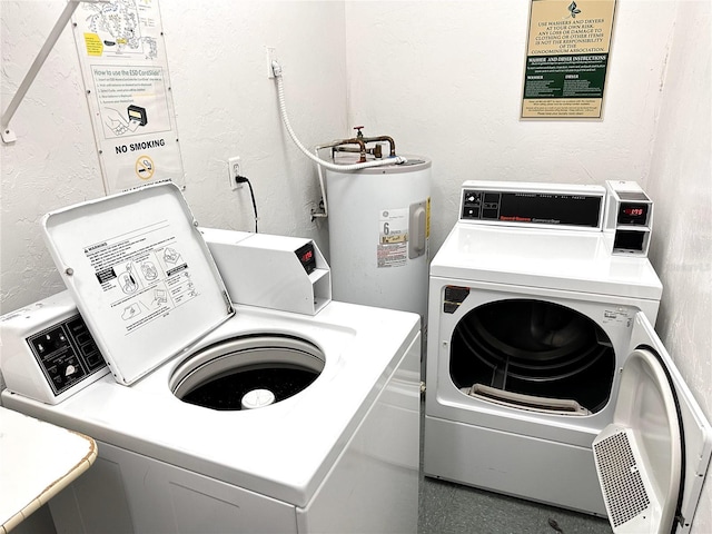 laundry area featuring a textured wall, separate washer and dryer, and electric water heater