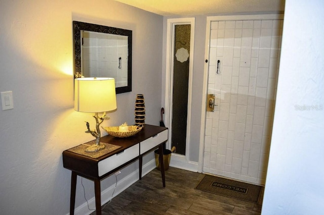 bathroom with baseboards and wood finished floors