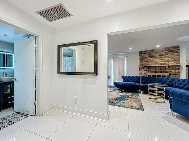 corridor with tile patterned flooring, visible vents, baseboards, and recessed lighting