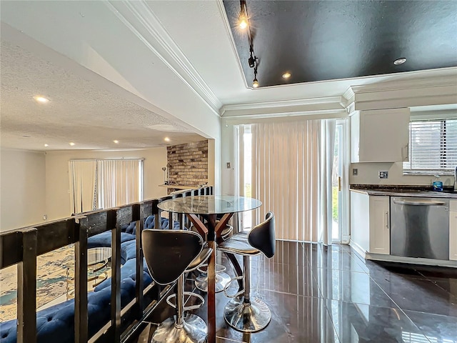 dining space with dark tile patterned floors, ornamental molding, a textured ceiling, and recessed lighting