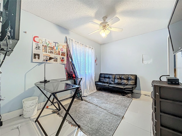 living room with ceiling fan and a textured ceiling