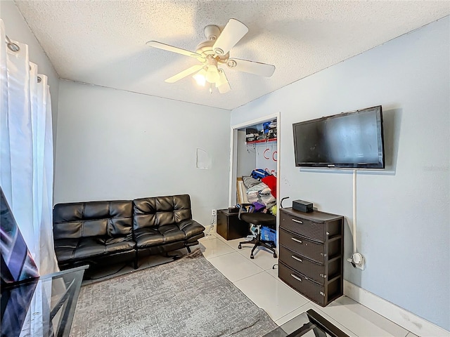 office with a textured ceiling, a ceiling fan, and tile patterned floors