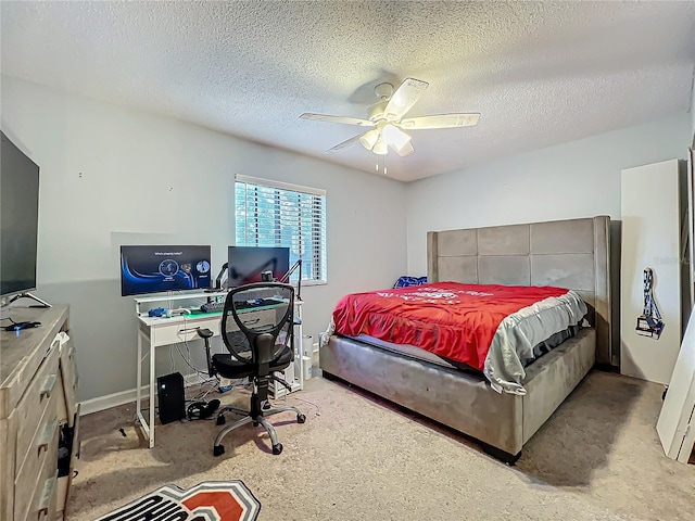 bedroom featuring a textured ceiling, carpet, and a ceiling fan