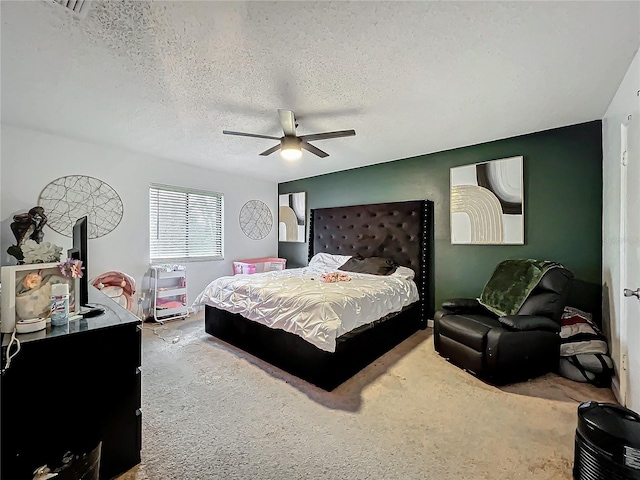 bedroom featuring carpet floors, ceiling fan, and a textured ceiling