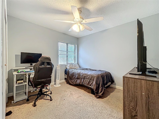 bedroom with a textured ceiling, carpet floors, a ceiling fan, and baseboards