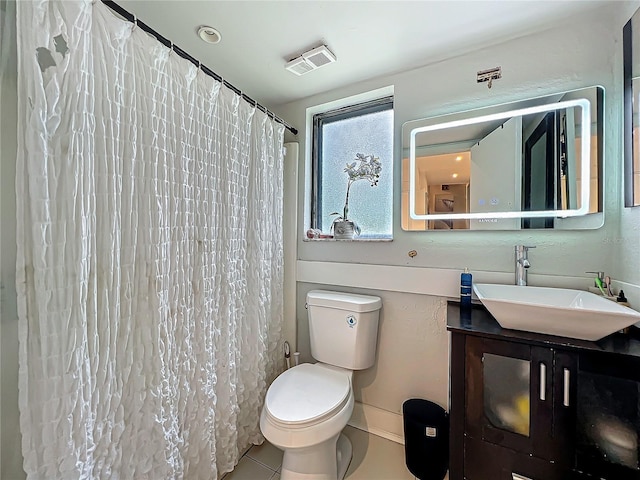 bathroom with toilet, vanity, visible vents, and tile patterned floors