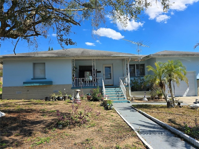 single story home with a porch and an attached garage