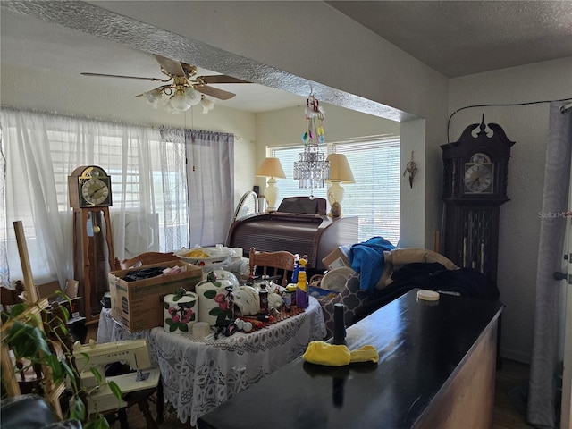 dining space featuring a ceiling fan and a textured ceiling