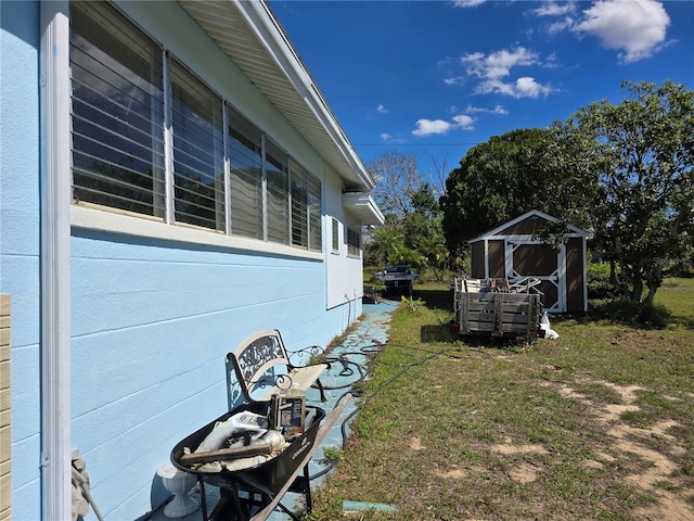 view of side of property with an outbuilding and a storage shed