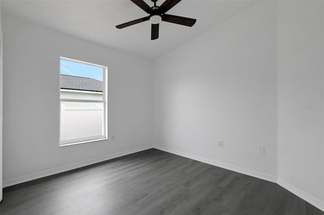 spare room with ceiling fan, dark wood finished floors, and baseboards