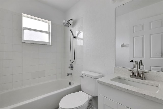 full bath with toilet, a textured wall, shower / washtub combination, and vanity