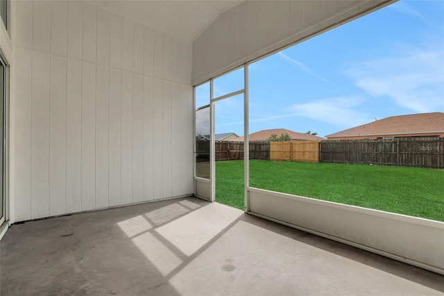 unfurnished sunroom featuring vaulted ceiling