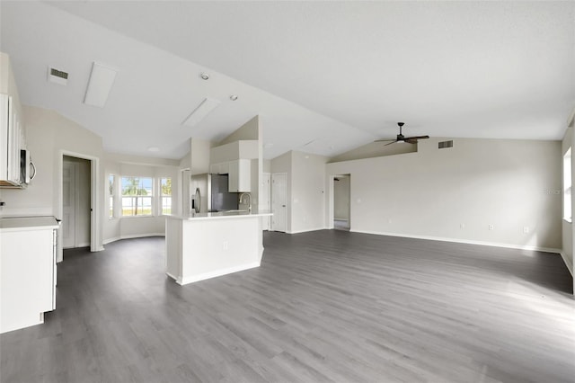 unfurnished living room with ceiling fan, dark wood finished floors, visible vents, and lofted ceiling