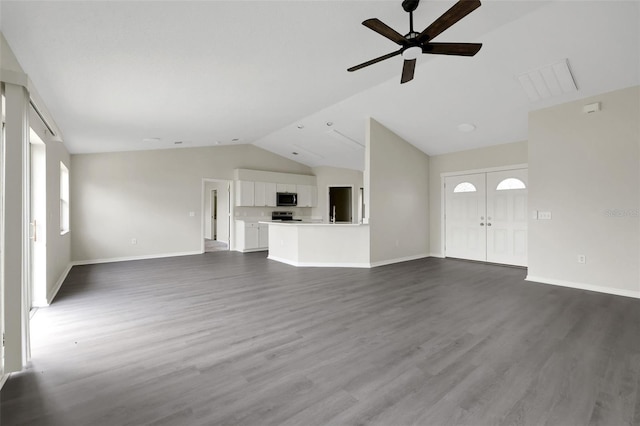 unfurnished living room featuring dark wood-type flooring, vaulted ceiling, and baseboards