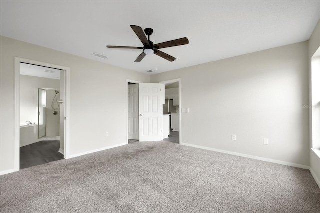 unfurnished bedroom with carpet, visible vents, ensuite bathroom, a ceiling fan, and baseboards