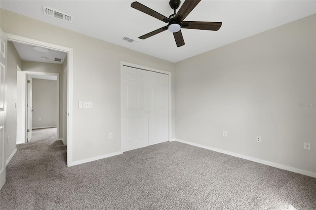 unfurnished bedroom featuring carpet floors, a closet, visible vents, and baseboards