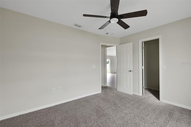 unfurnished bedroom with ceiling fan, carpet, visible vents, and baseboards