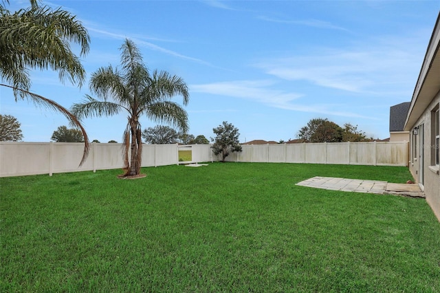 view of yard with a fenced backyard