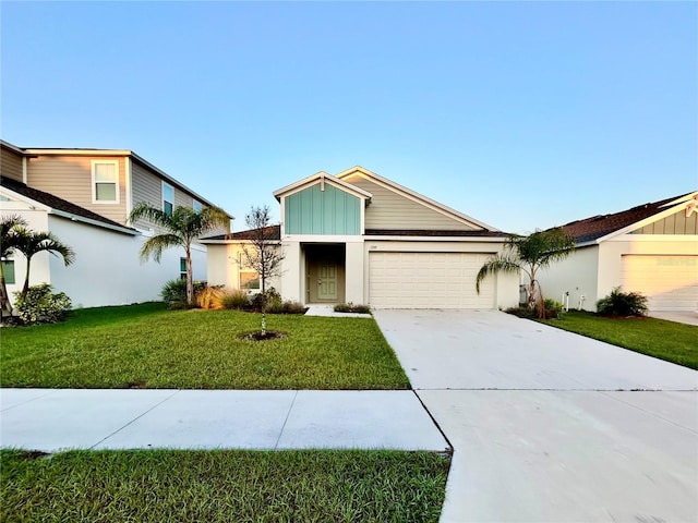 view of front of house featuring driveway, a garage, a front lawn, and board and batten siding