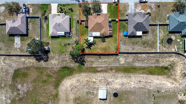 birds eye view of property with a residential view